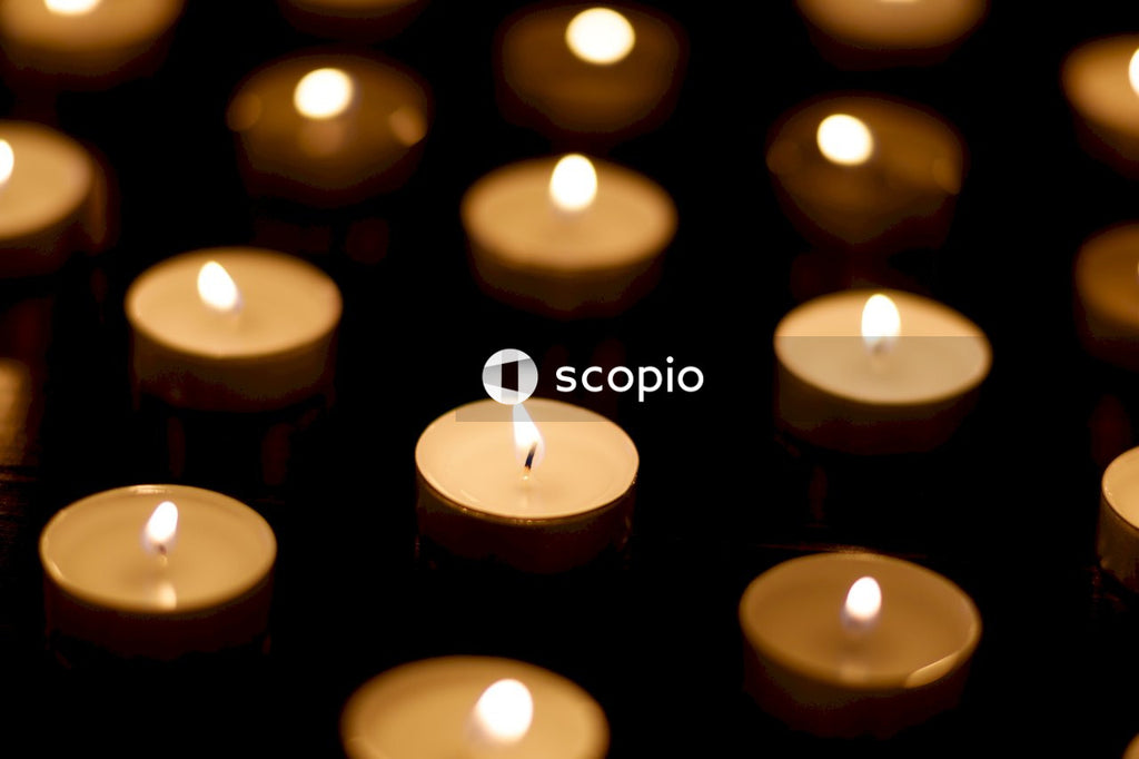 Lighted candle on brown candles