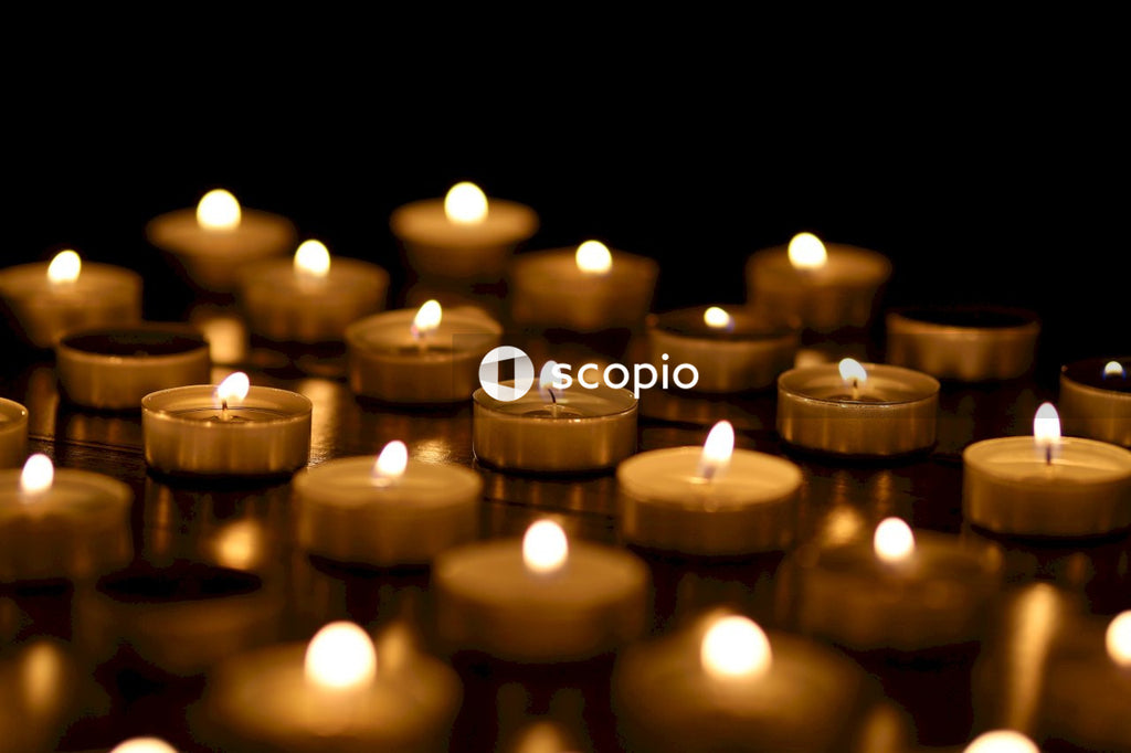 Lighted candles on brown wooden table