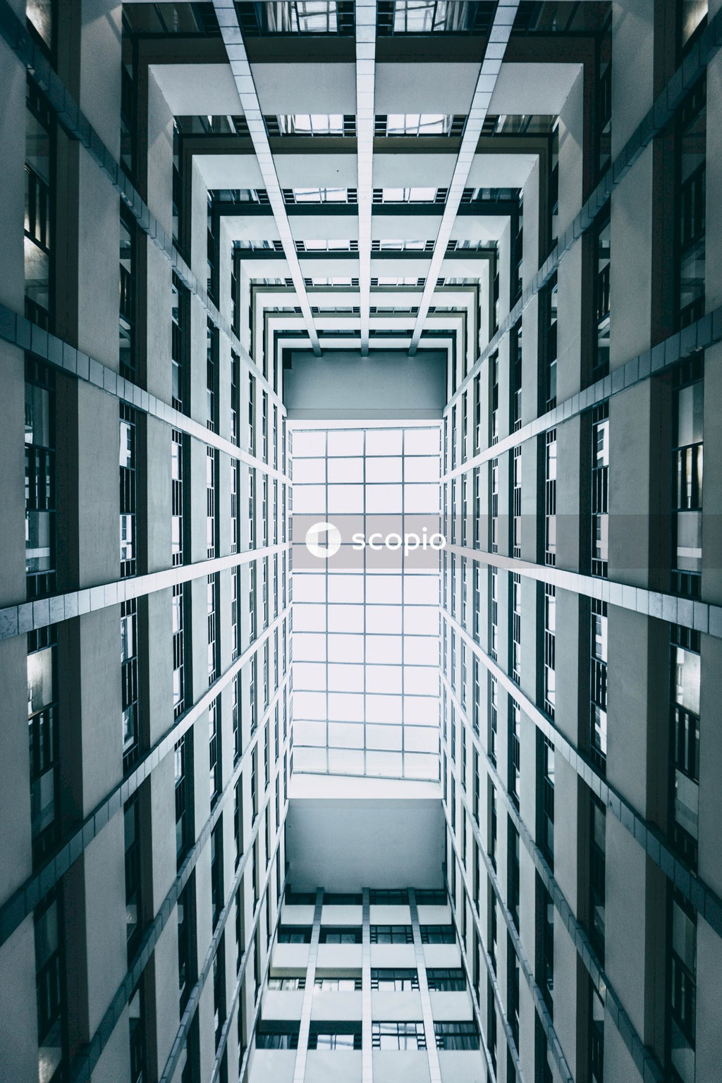 Low angle photo of glass ceiling inside high-rise building