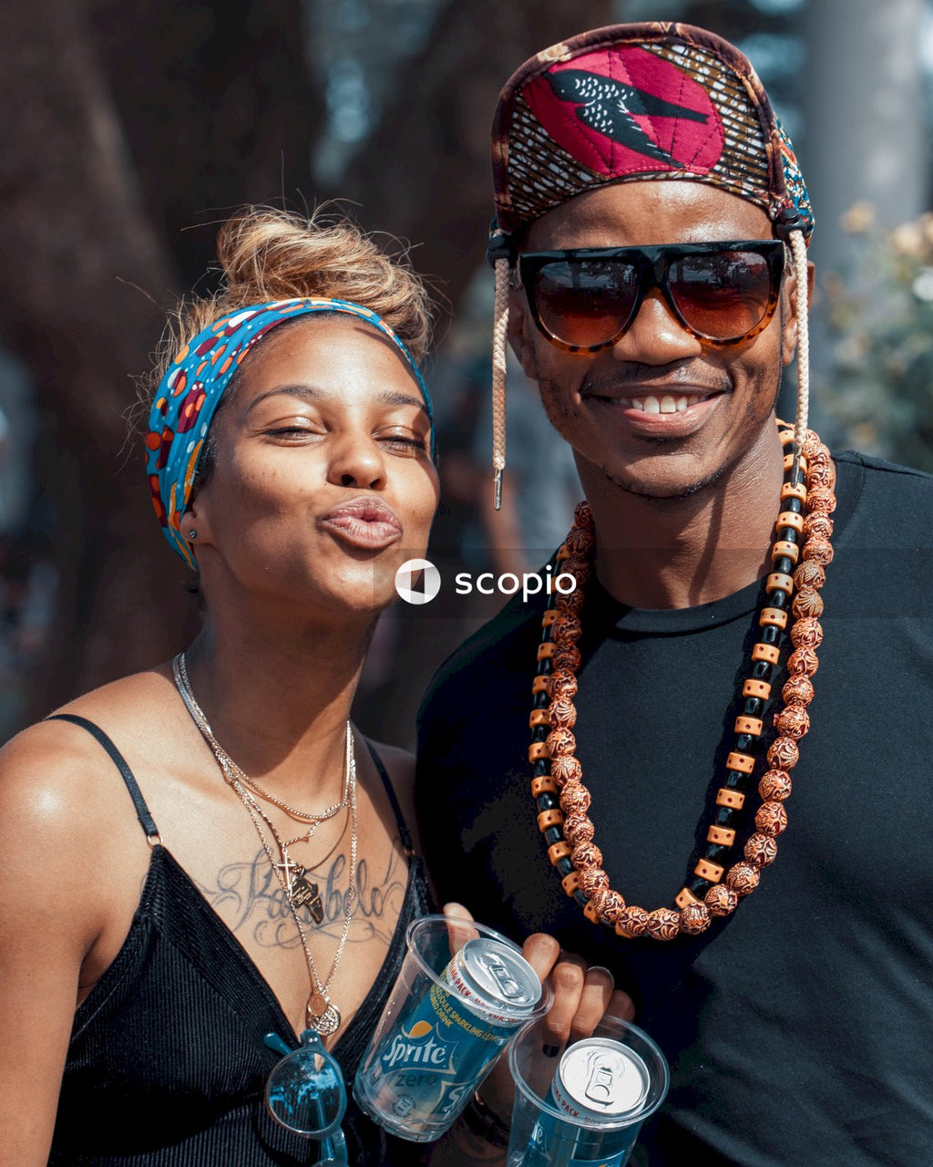 Man and a woman in bandanas smiling