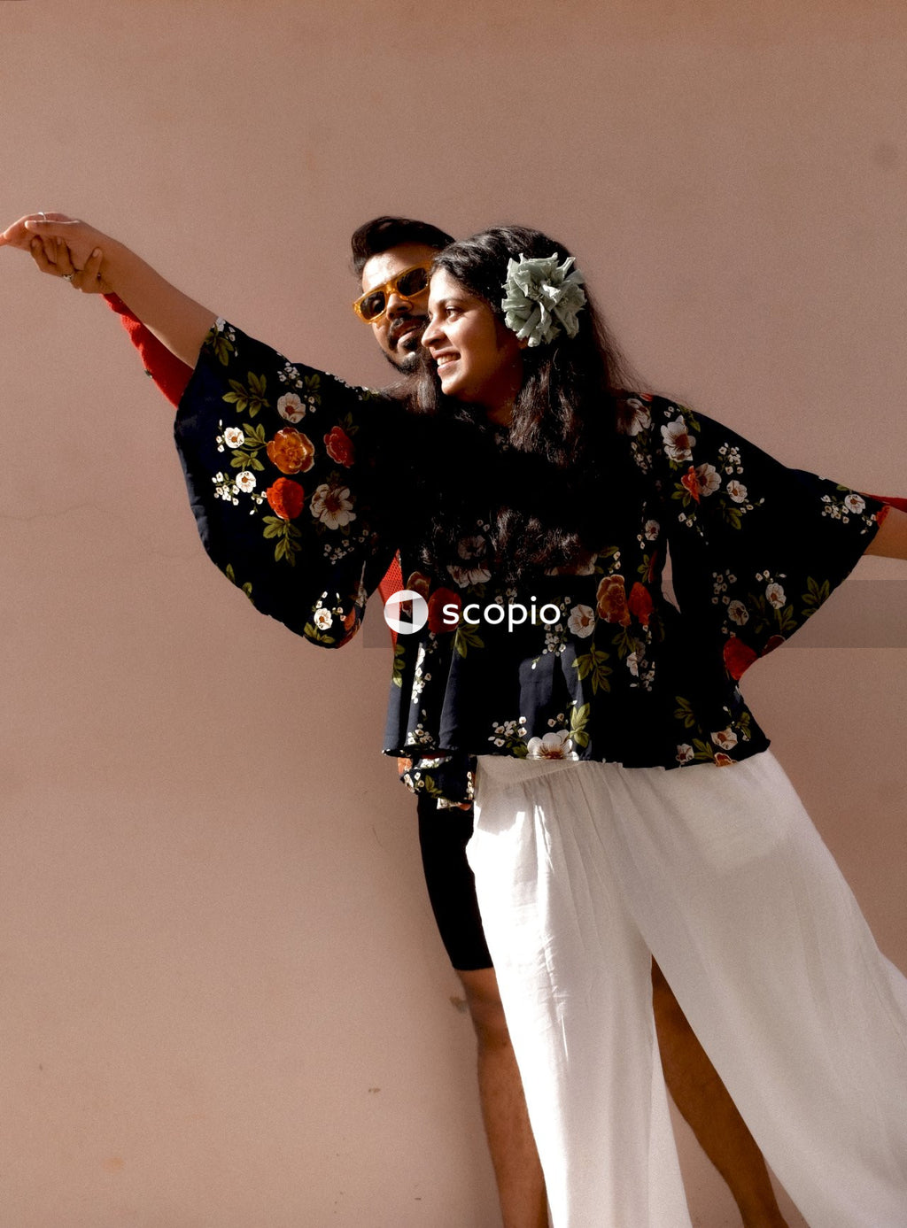 Man and woman dancing beside wall