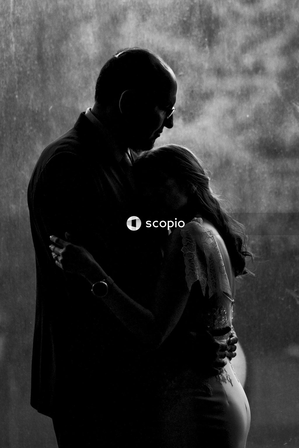 Grayscale photo of couple hugging