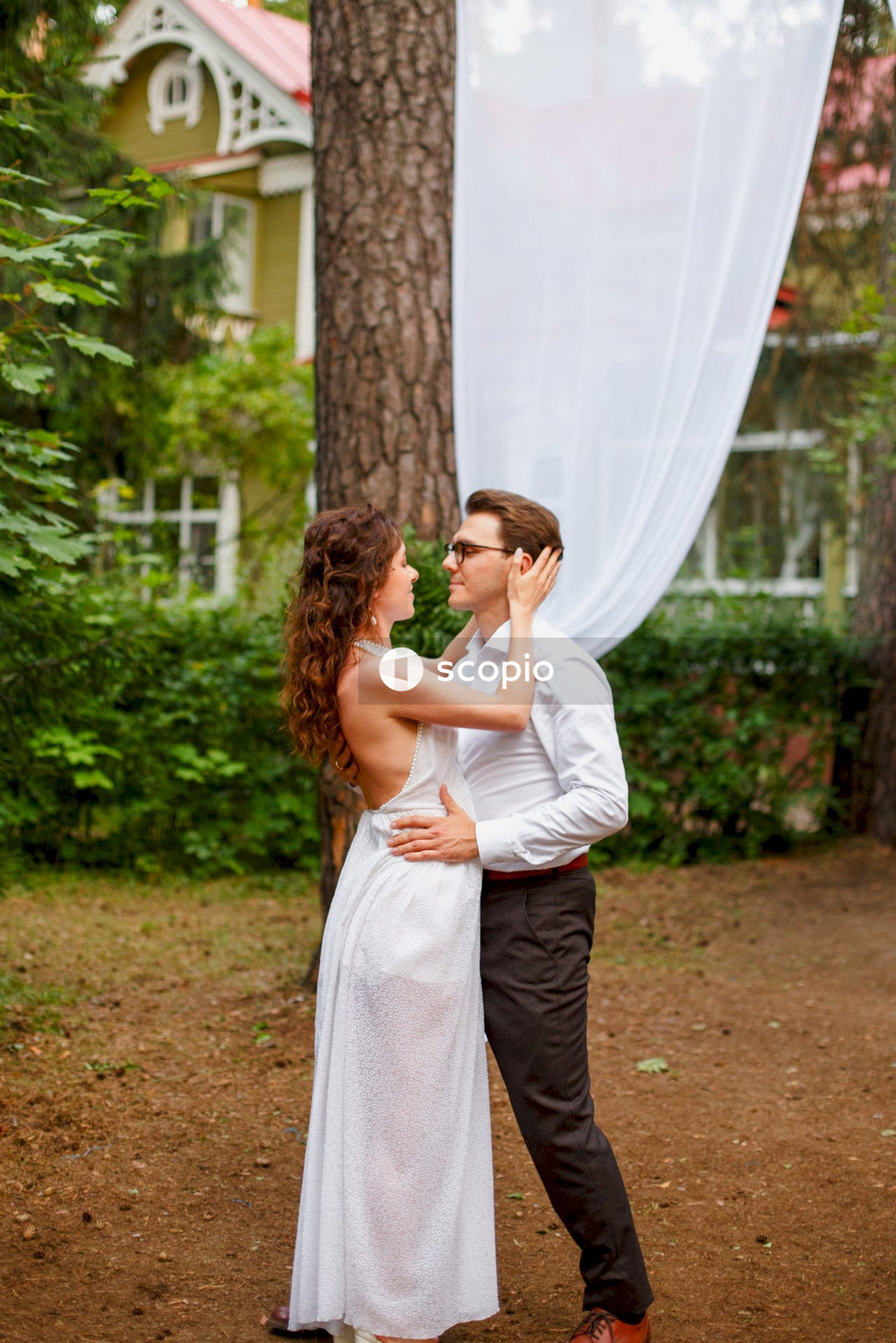 Man and woman kissing on green grass field