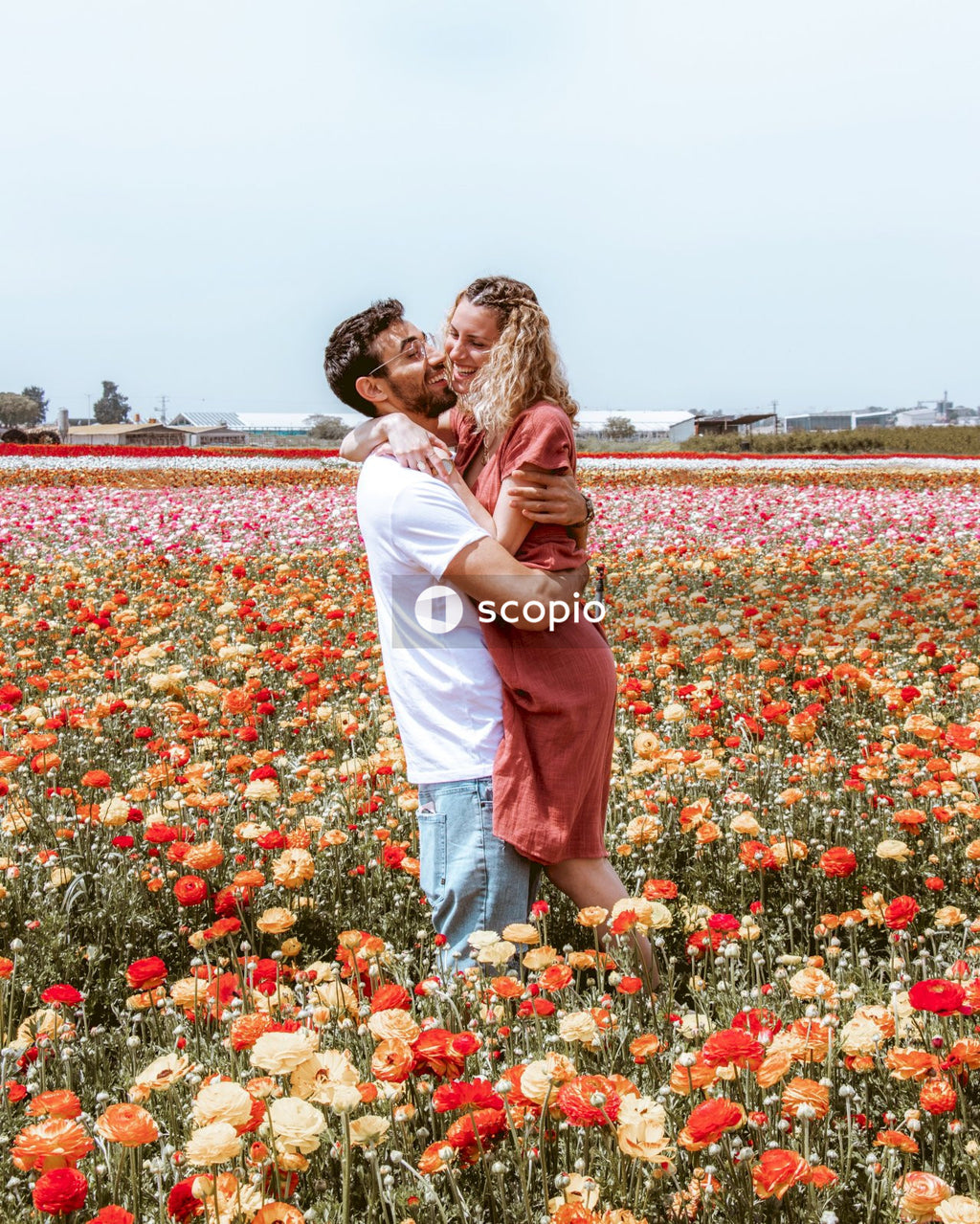 Man and woman kissing in flower meadow