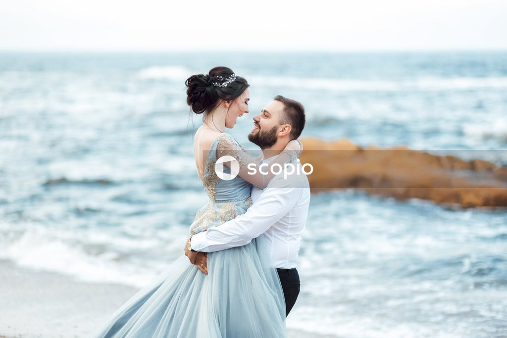 Man and woman kissing on seashore