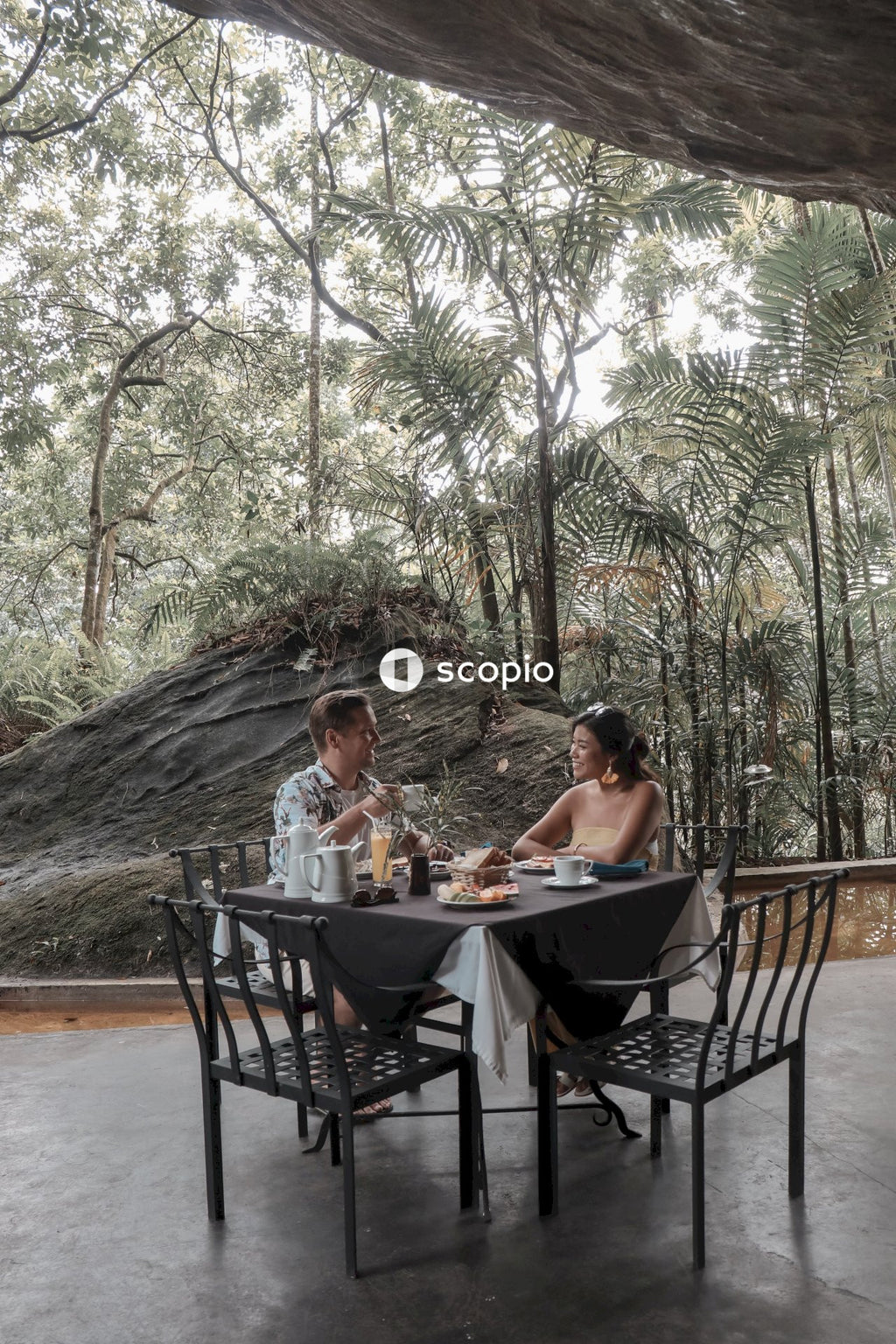 Man and woman on a date in a restaurant near trees during daytime