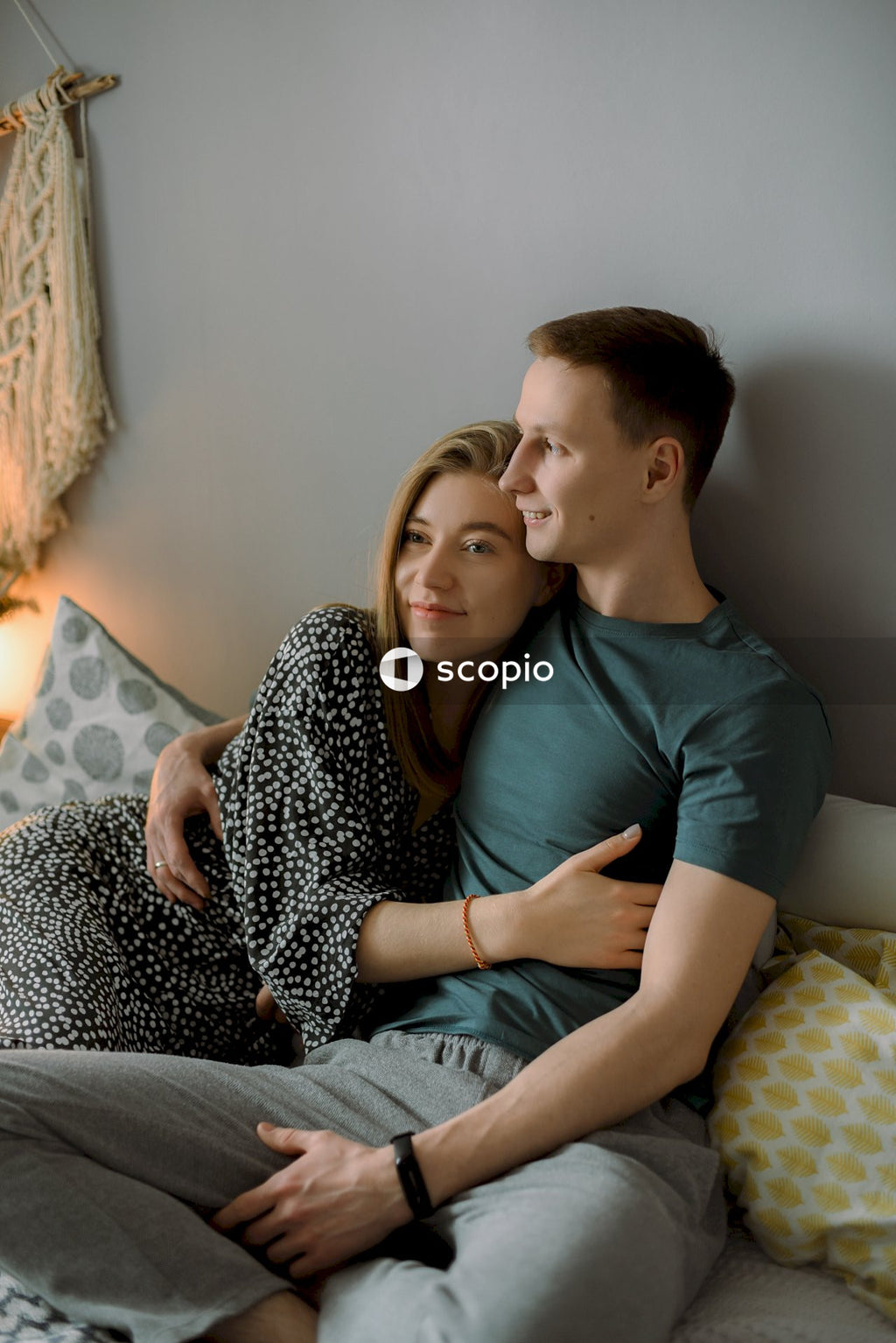 Man and a woman hugging each other in the living room