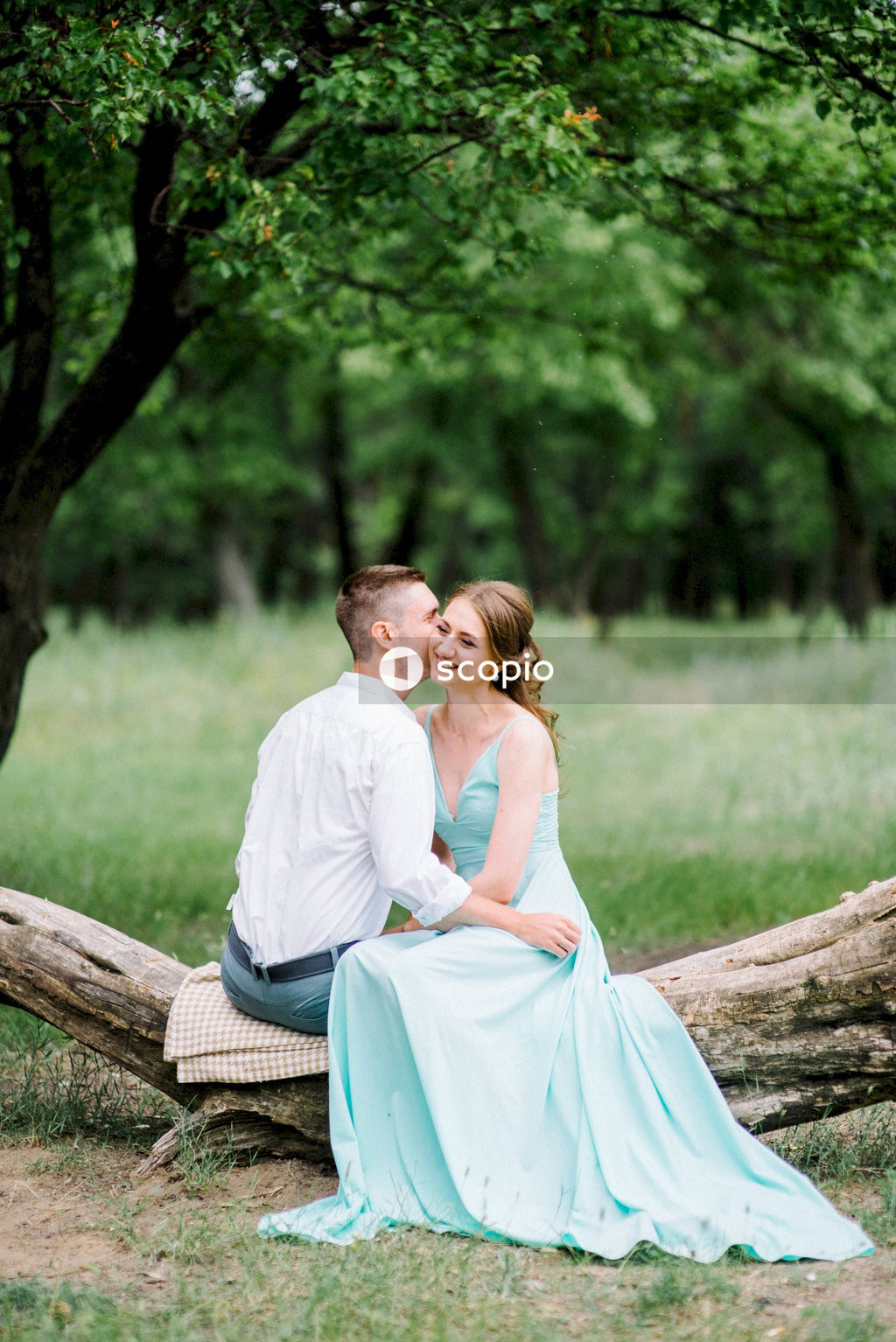 Man and woman sitting on brown wooden bench