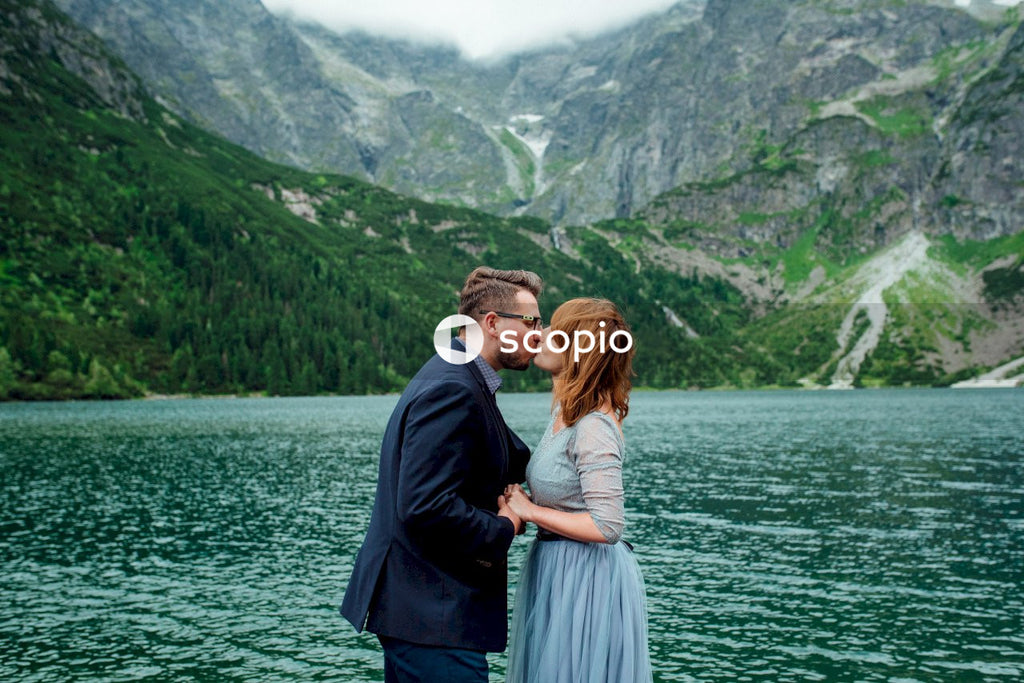 Man and woman standing on a dock by a lake