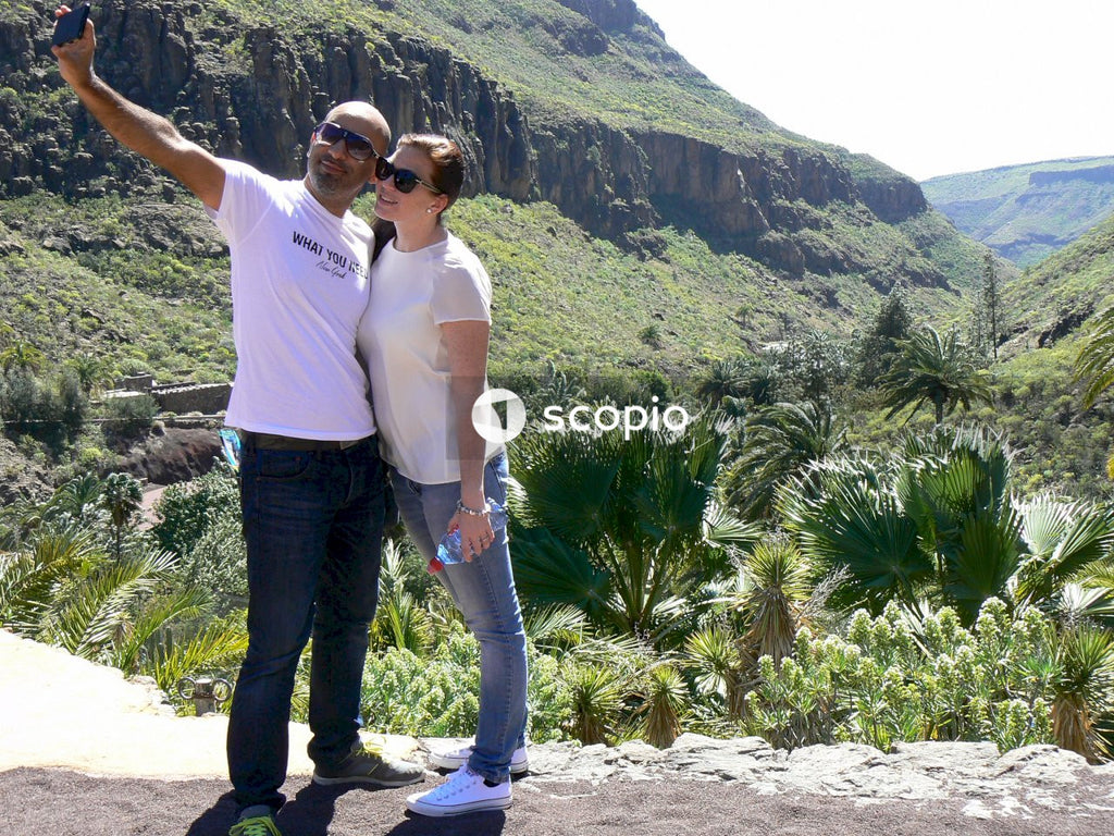 Man and woman taking selfie standing outdoor in nature