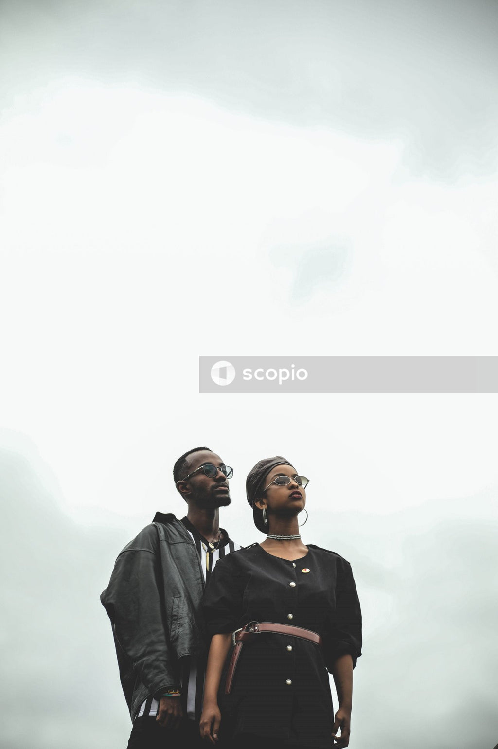 Man and woman standing under clear skies