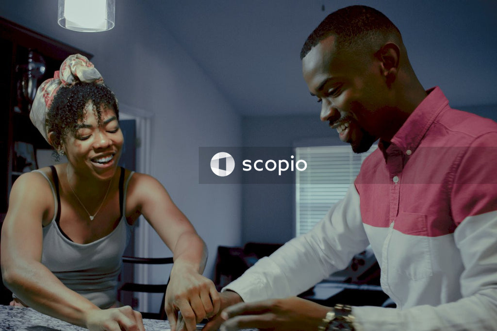 Man and woman playing board game at home
