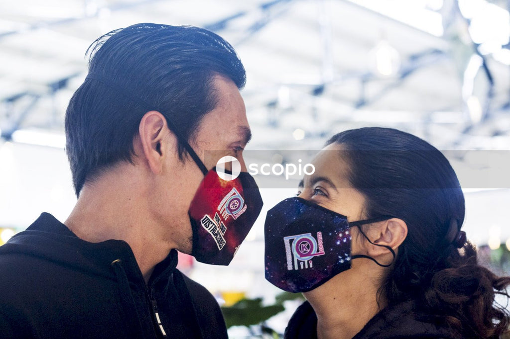 Man and woman with facemask looking at each