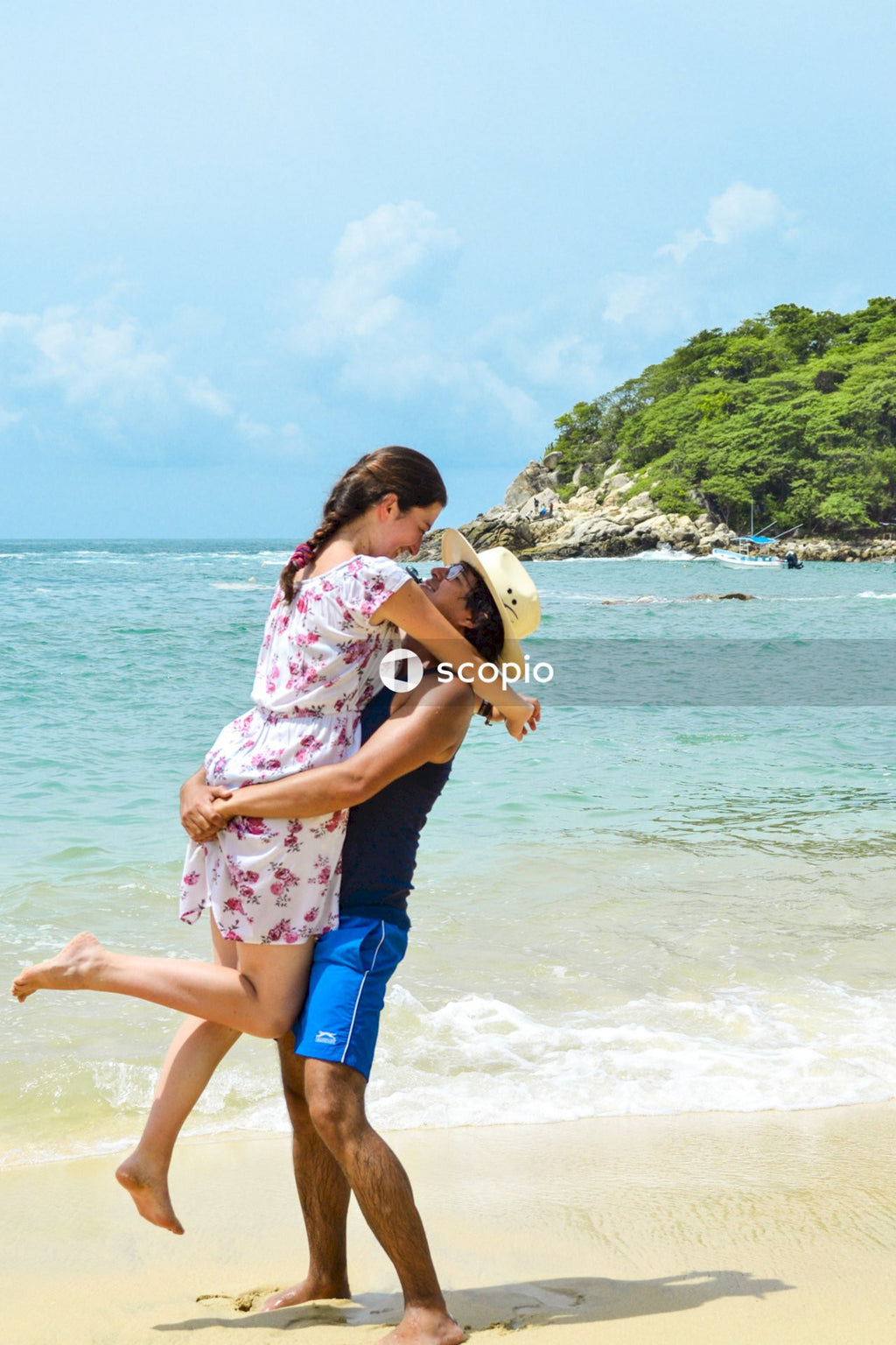 Man carrying a woman at the beach