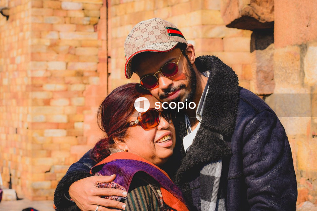 Man hugging woman in front of building