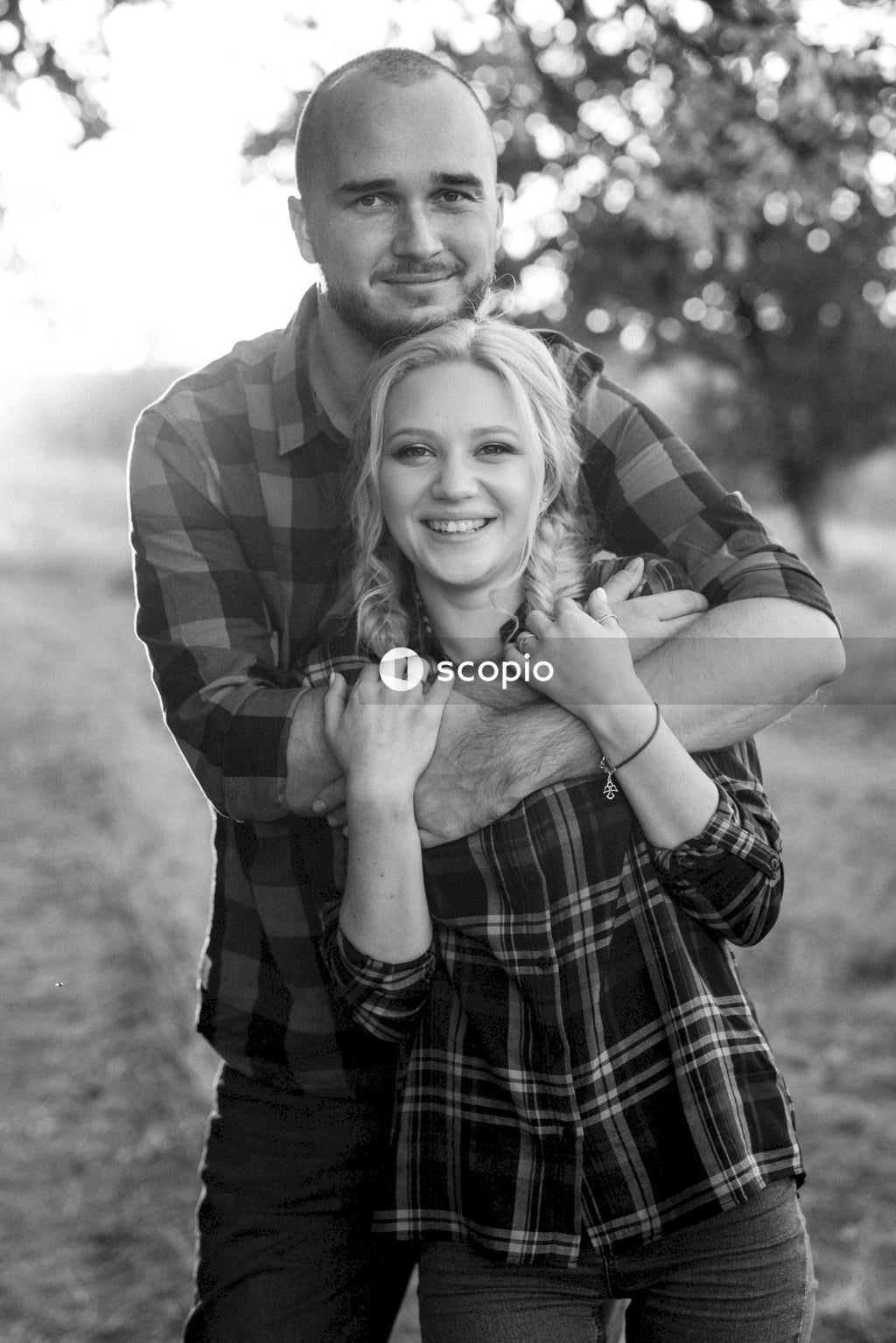 Man hugging woman in grayscale