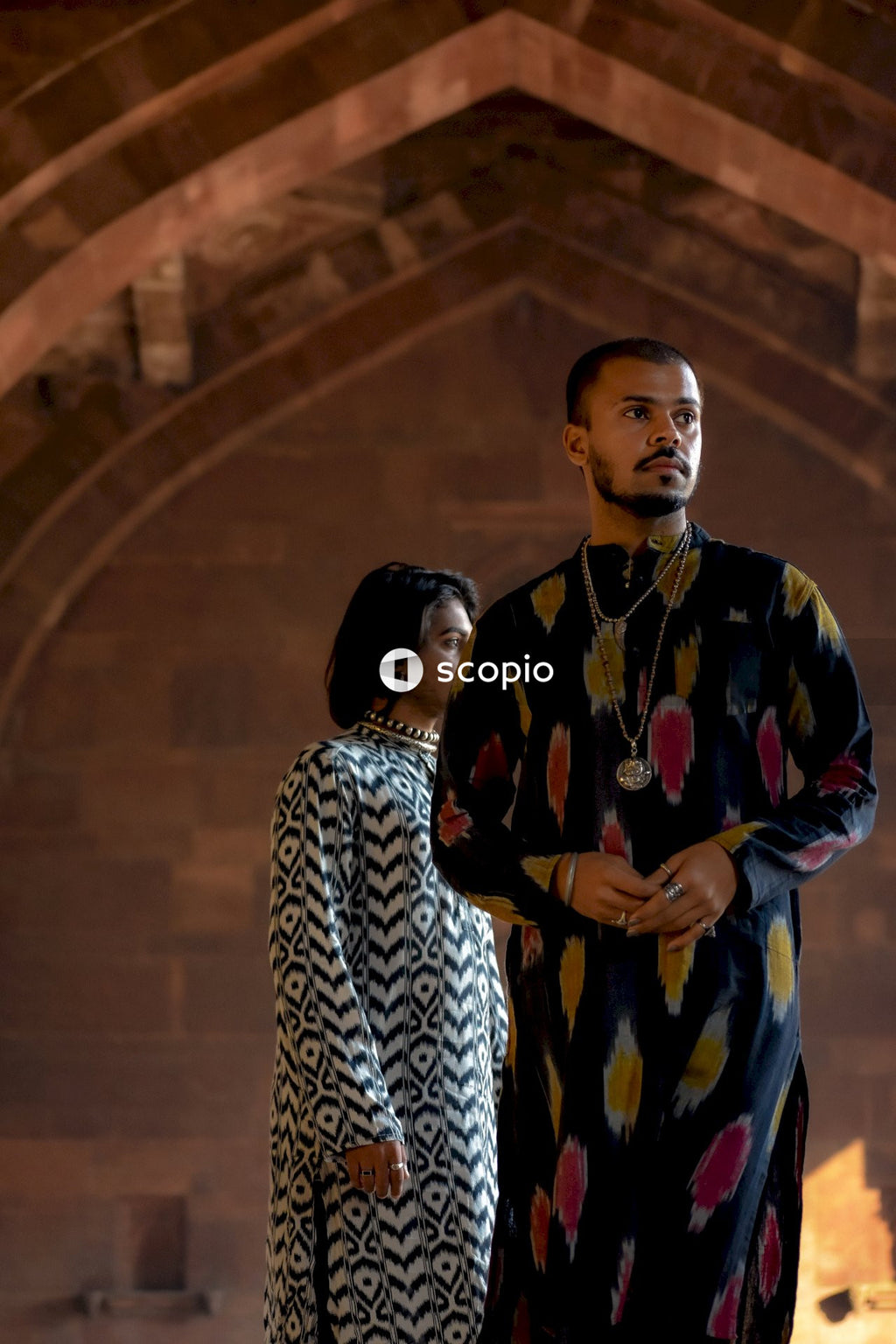 Two genderqueer men having romantic moments in an Indian ancient building