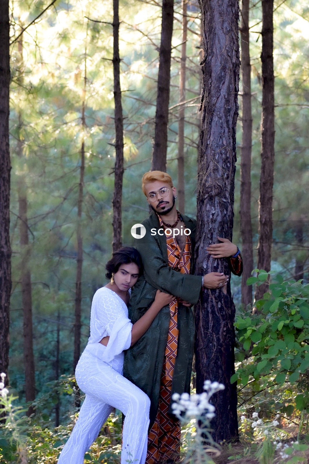 Two genderqueer man in stylish outfits having romantic moments outdoor in the nature