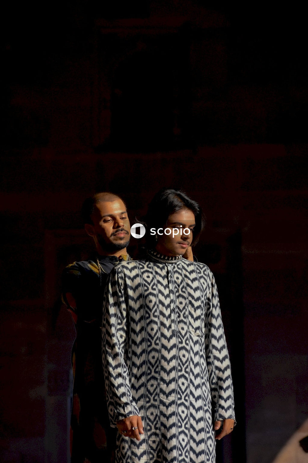 Two genderqueer men having romantic moments in an Indian ancient building