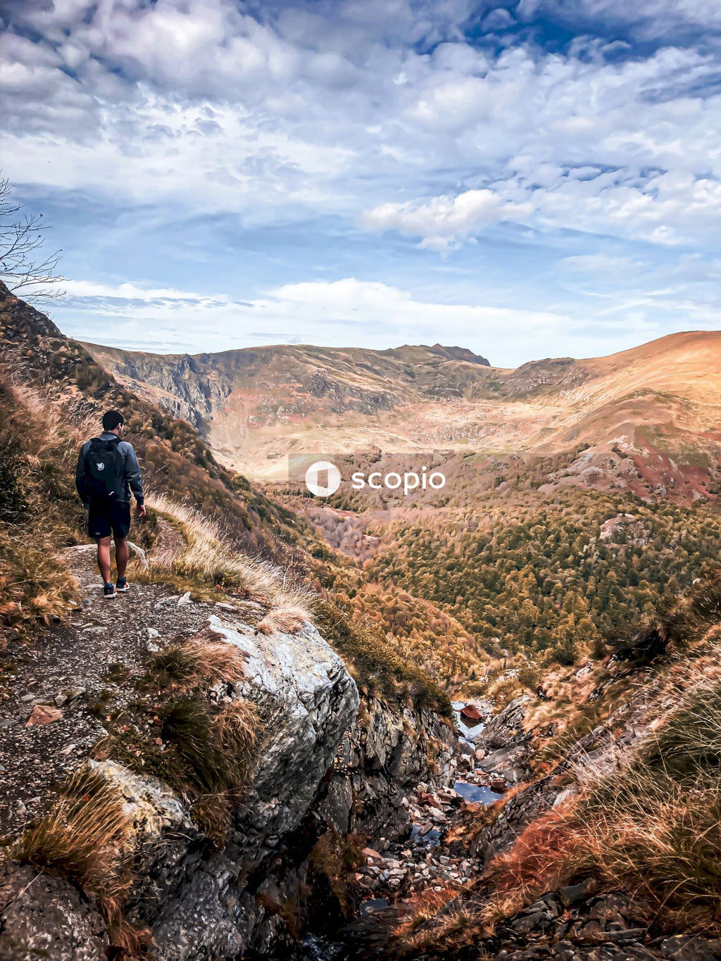 Man in black jacket standing on rocky mountain