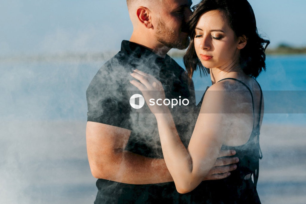 Man in black shirt hugging woman in black tank top
