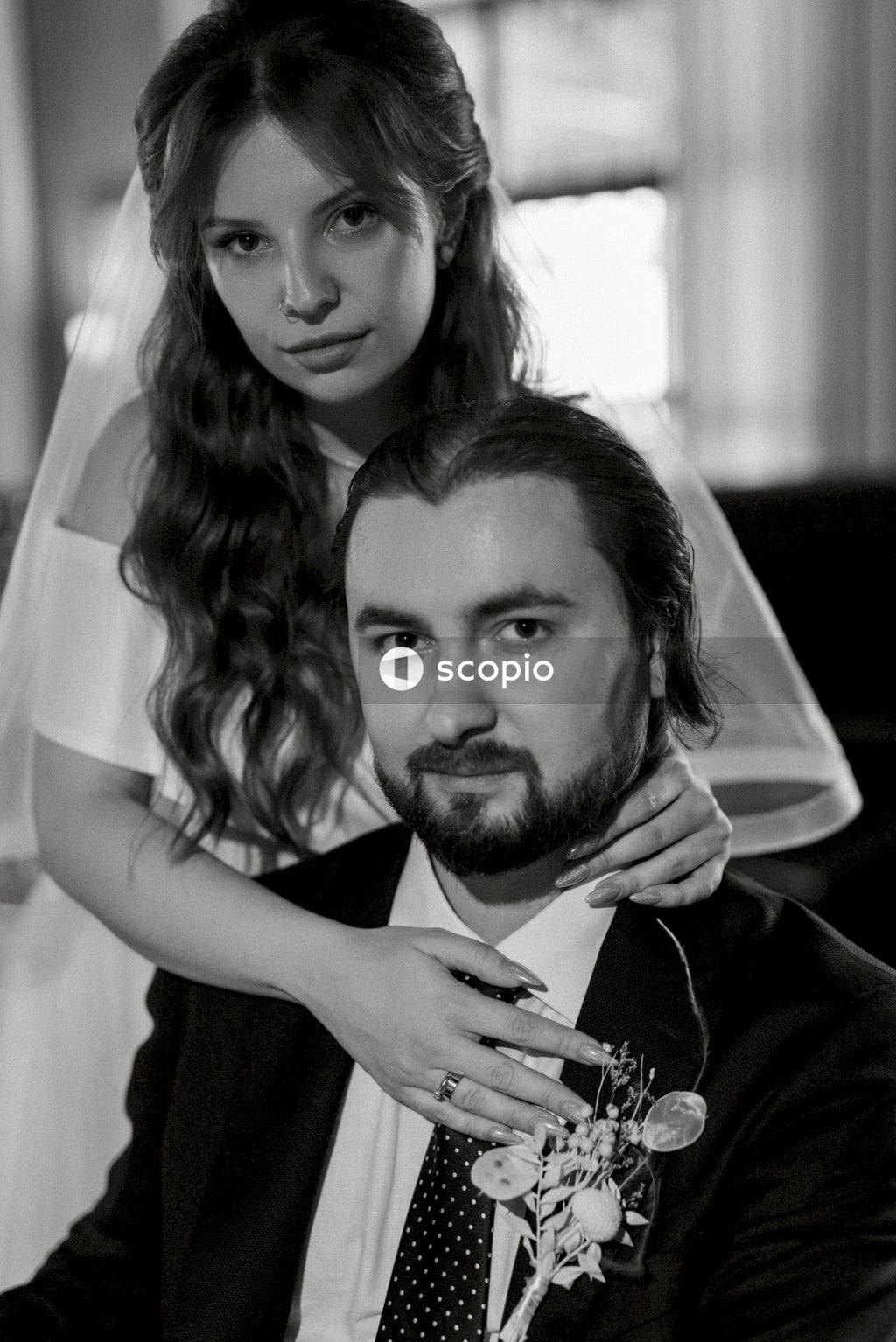 Man in black shirt hugging woman in white dress