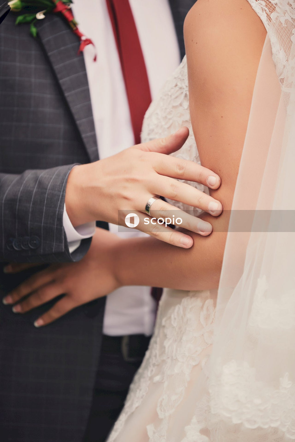 Man in black suit jacket and woman in white wedding dress