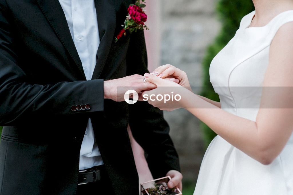 Cropped image of bride and groom holding hands