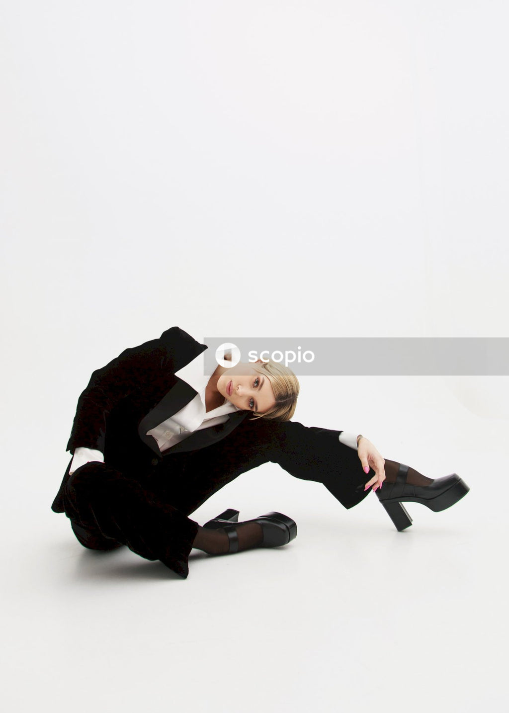 Man in black suit lying on floor