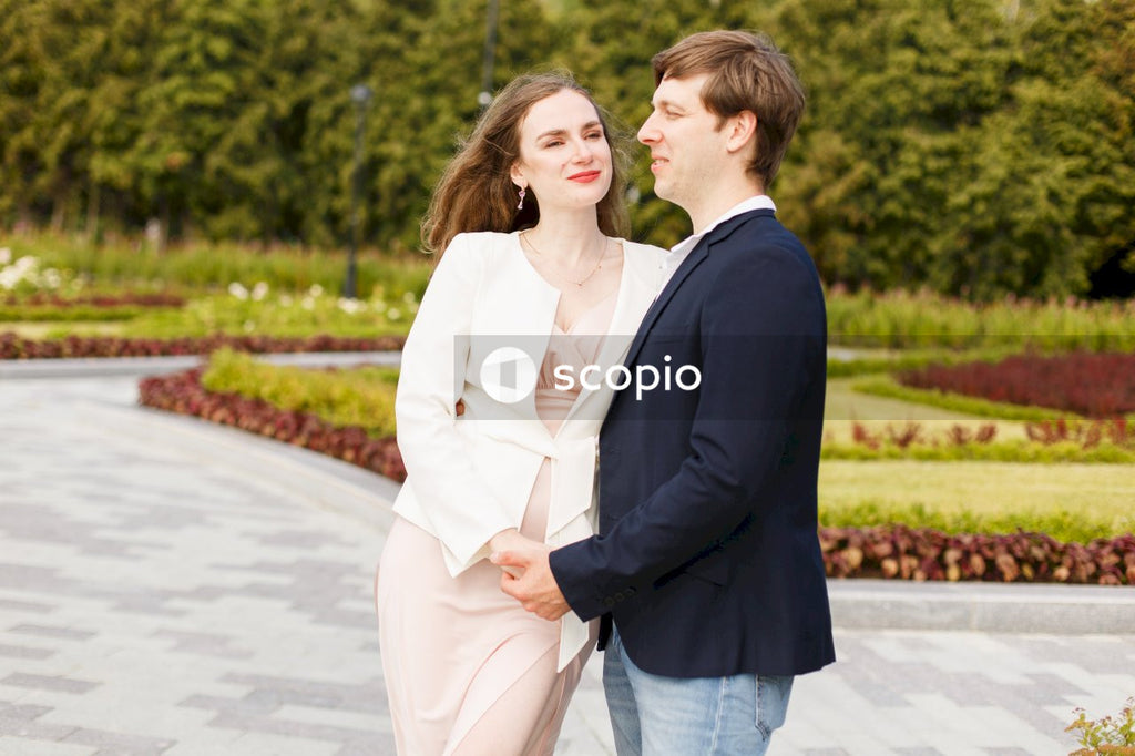 Man in black suit standing beside woman in white dress