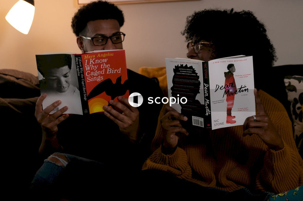Couple reading books and looking at each other in living room