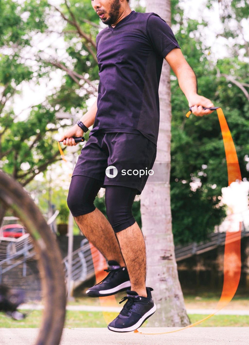 Man in black t-shirt and black shorts doing skateboard stunts