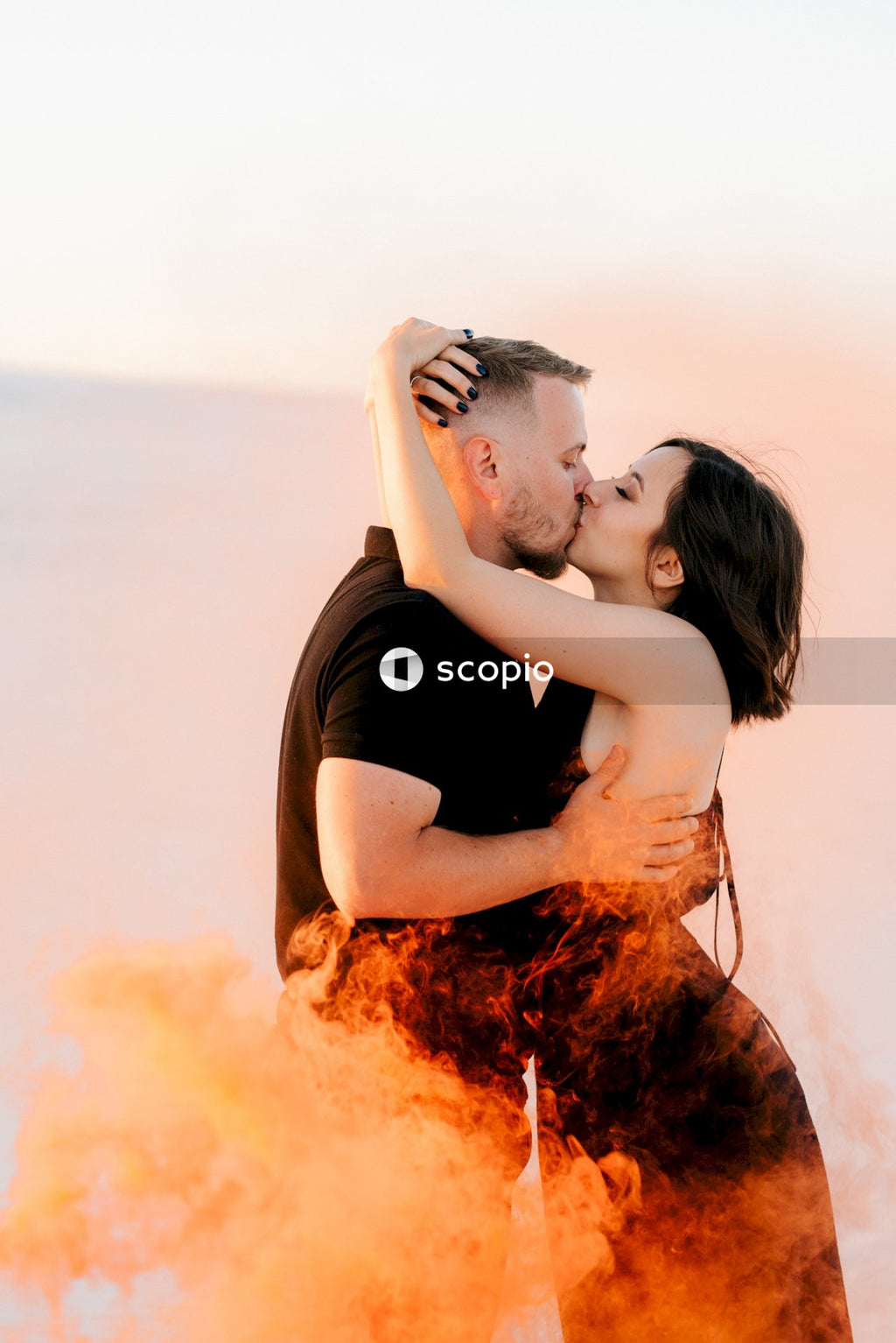 Man in black t-shirt hugging woman in black tank top