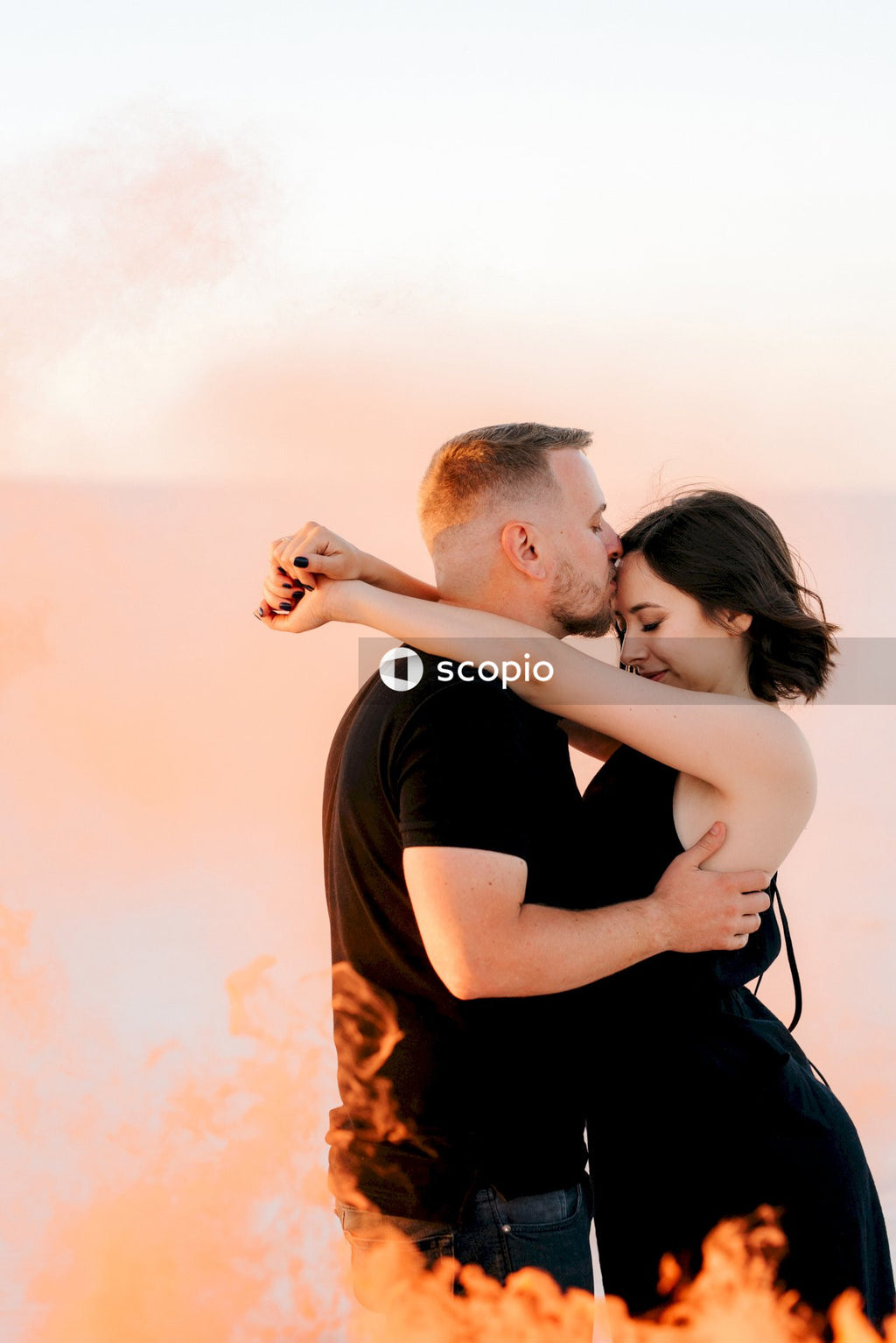 Man in black t-shirt kissing woman in black tank top