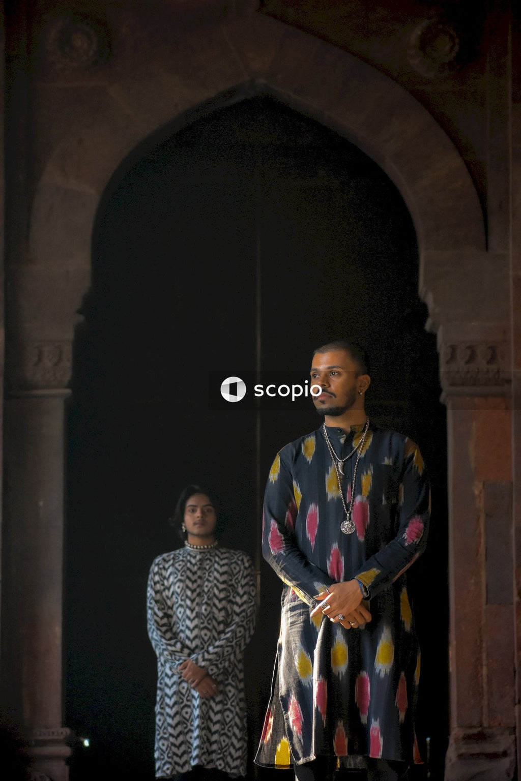 Two genderqueer men having romantic moments in an Indian ancient building