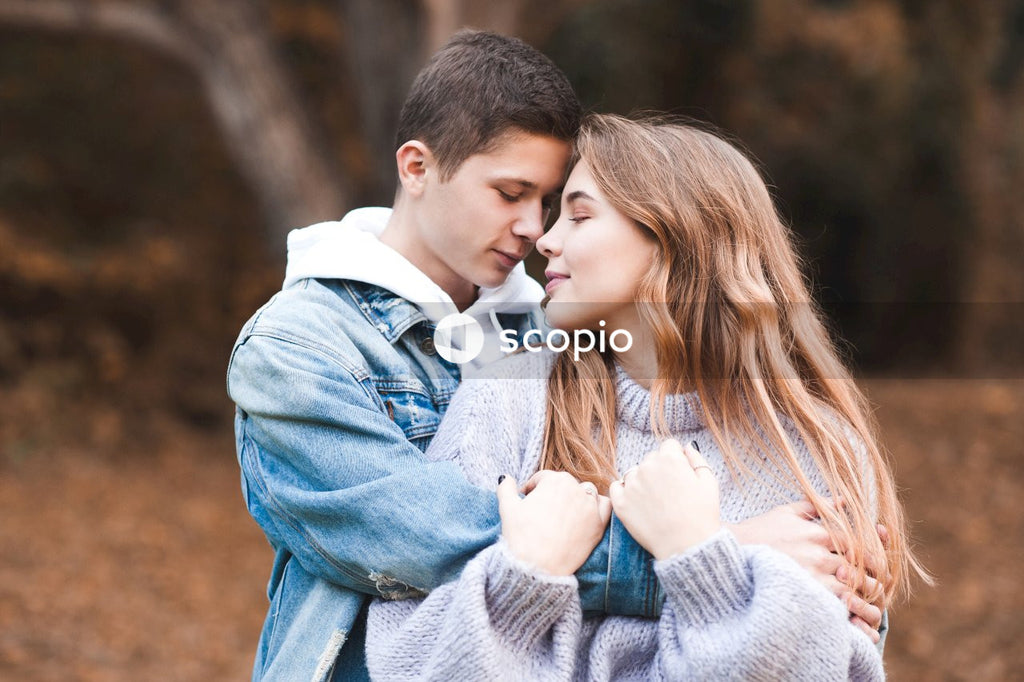 Romantic teenage couple wear casual clothes in autumn park outdoor