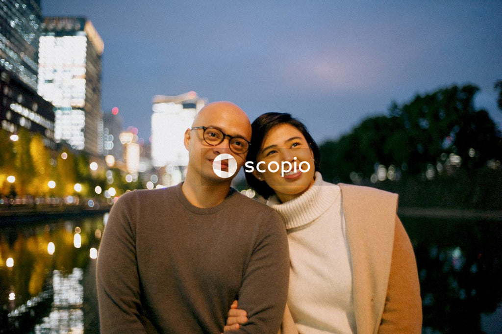 Southeast Asian couple standing outdoor in the city at night