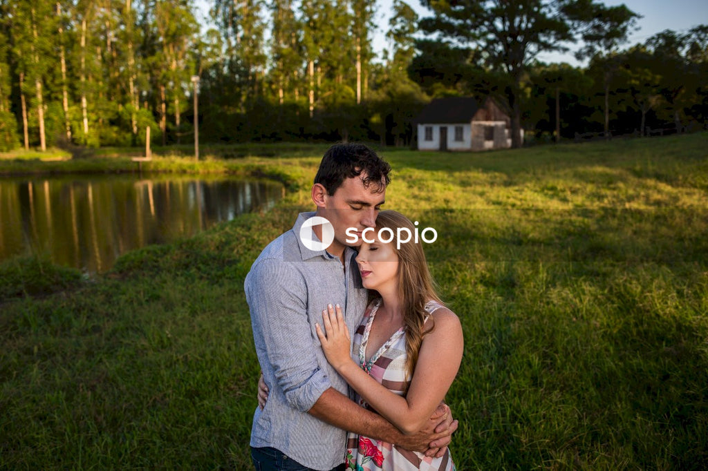 Man in gray shirt hugging woman in gray tank top