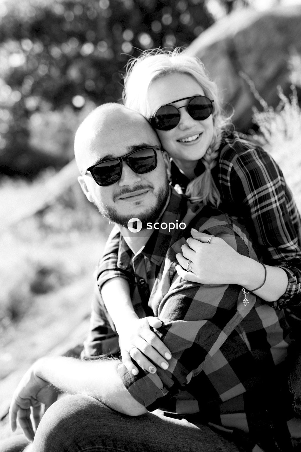 Man in plaid shirt hugging woman in plaid shirt
