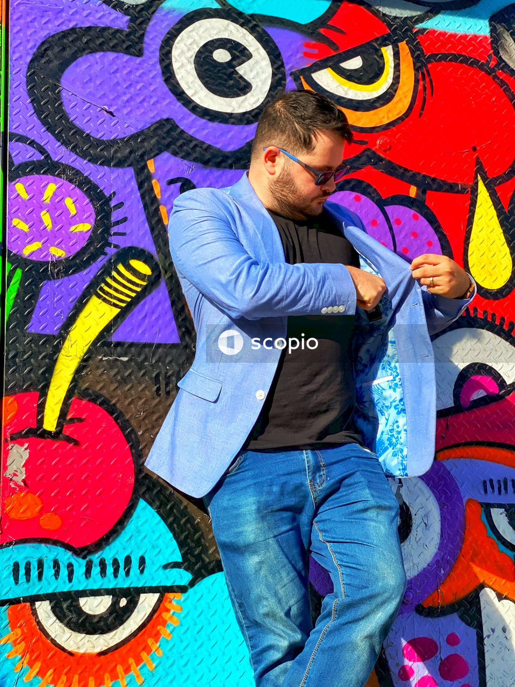 Man in purple dress shirt hugging woman in blue denim jeans