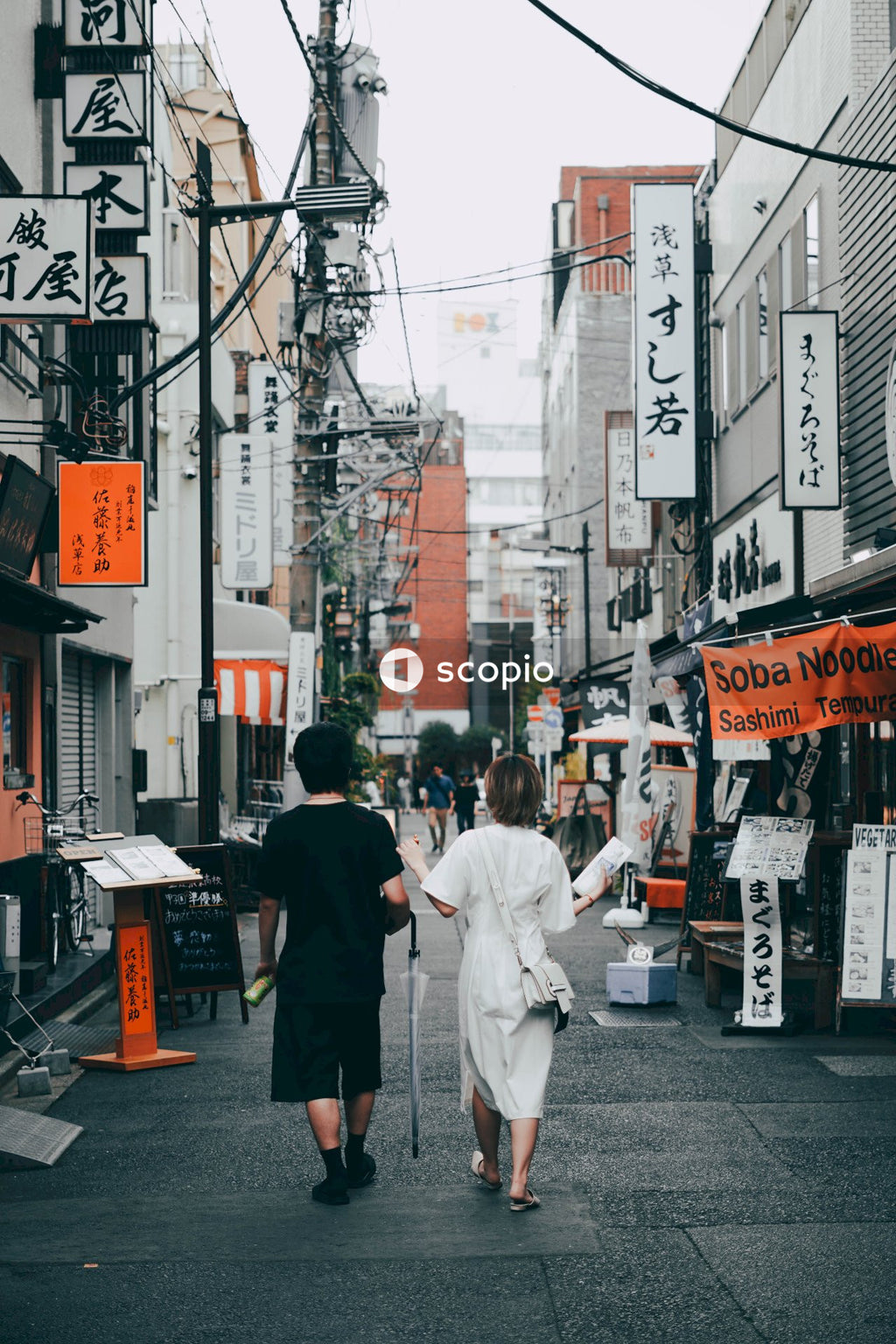 Man in white dress shirt and black pants walking on street
