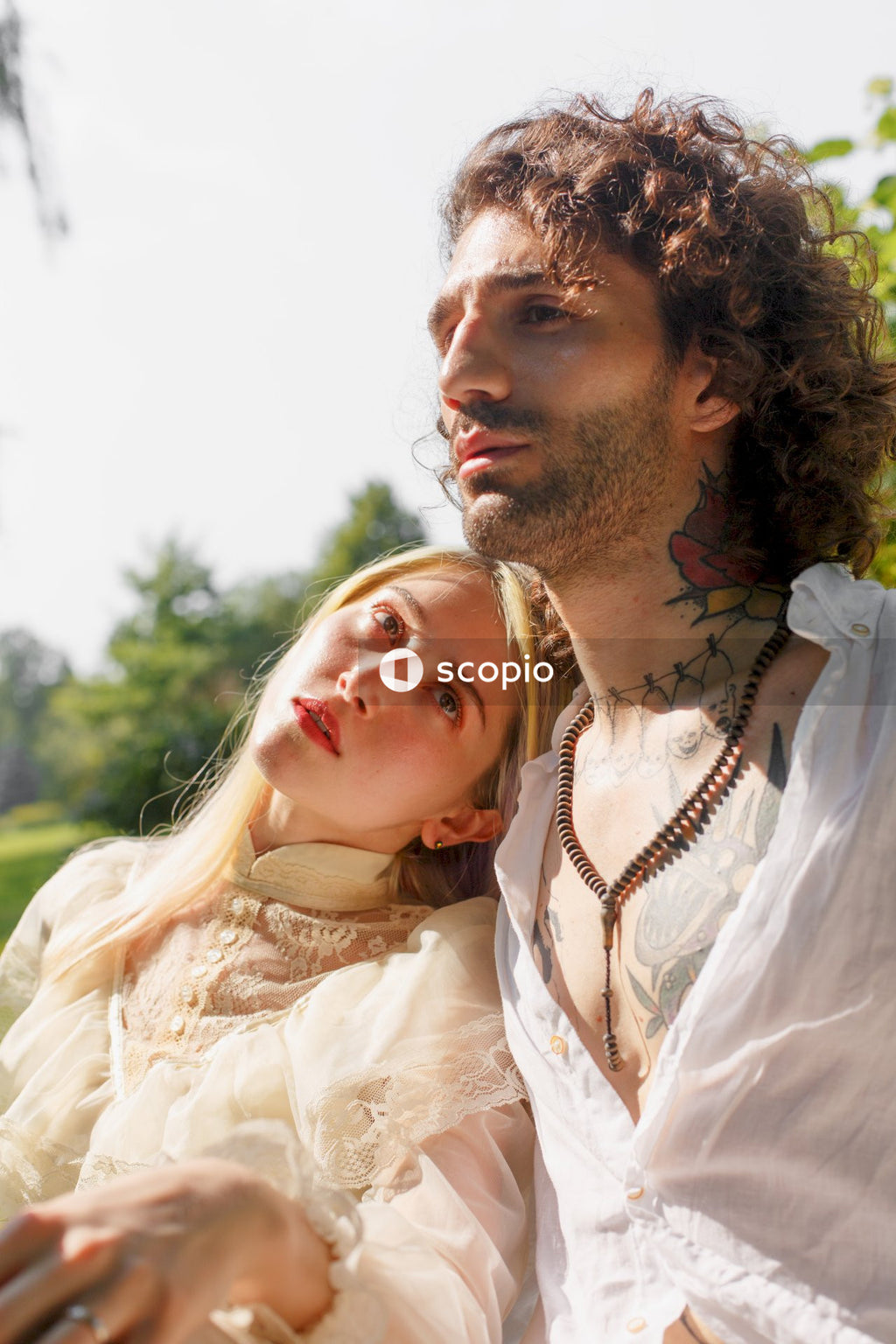 Man in white dress shirt beside woman in white dress