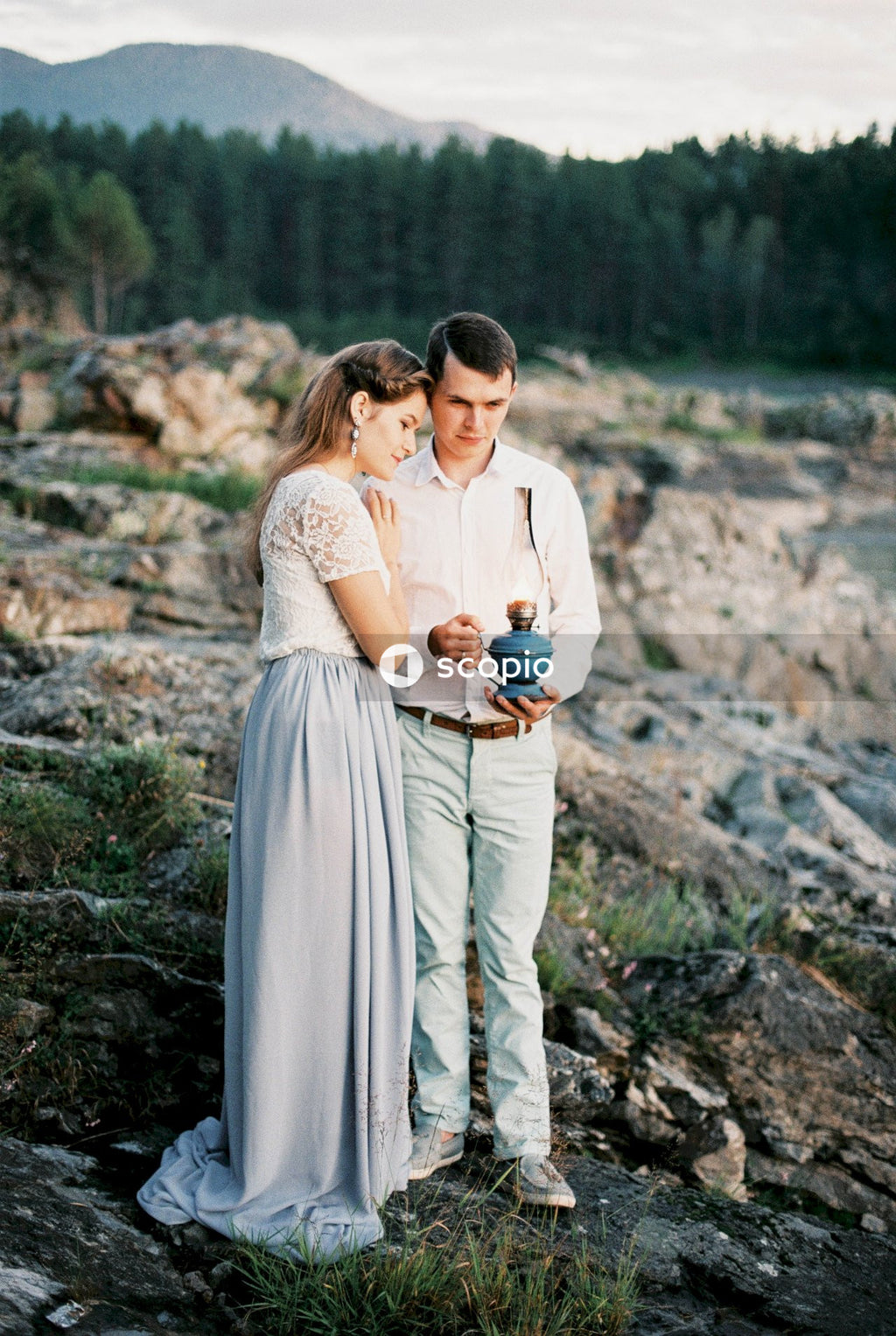 Man in white dress shirt hugging woman in white dress