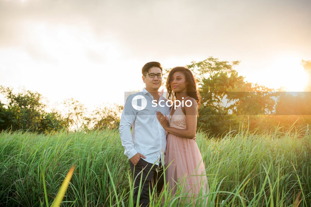 Man in white dress shirt hugging woman in white dress