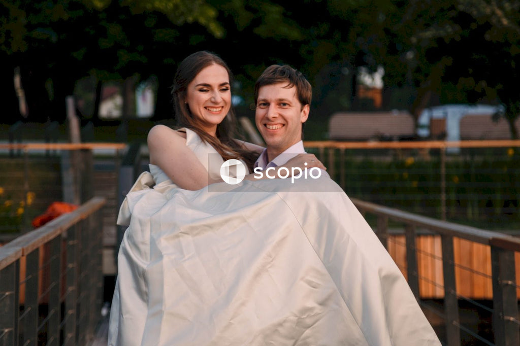 Man in white dress shirt hugging woman in white dress