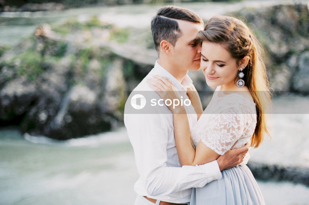 Man kissing woman in wedding dress