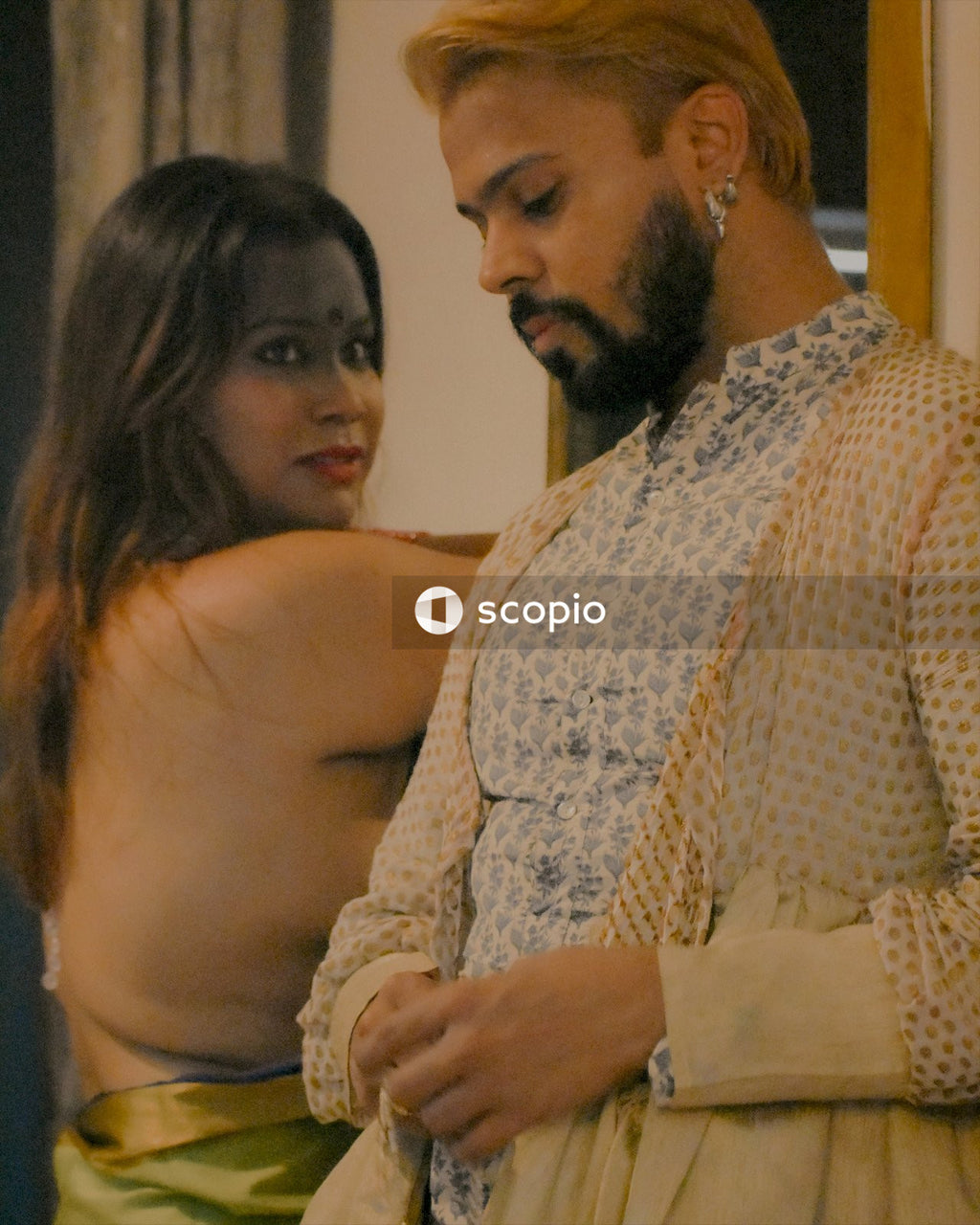 South Asian man and woman standing beside each other indoor