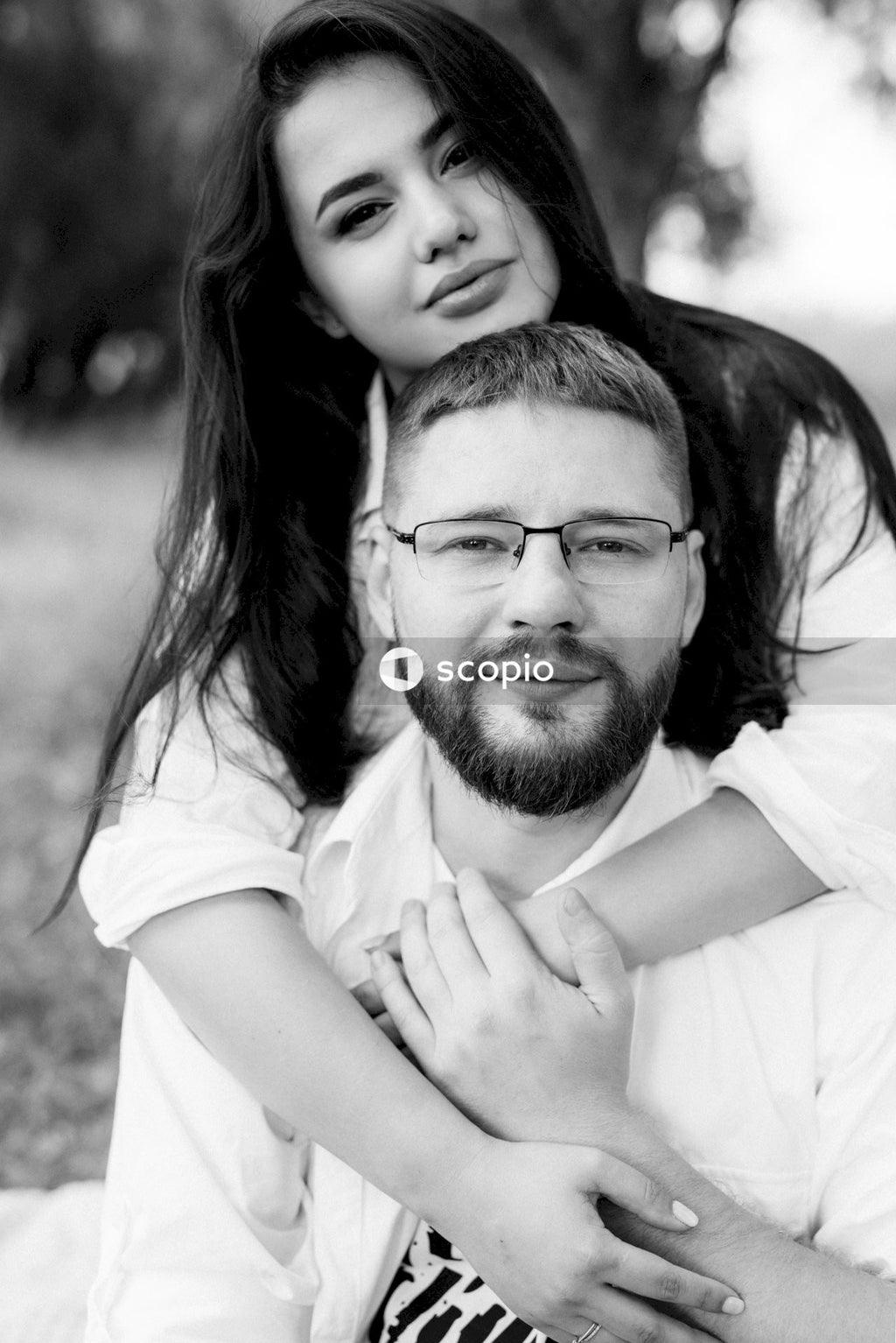 Man in white shirt hugging woman in white shirt