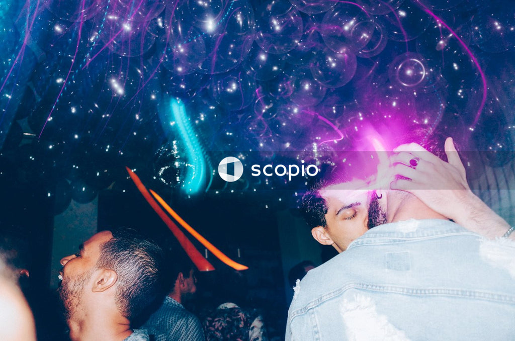 Two men kissing at a party