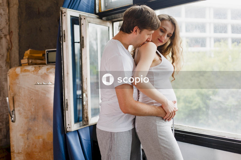 Man in white t-shirt hugging woman in white t-shirt